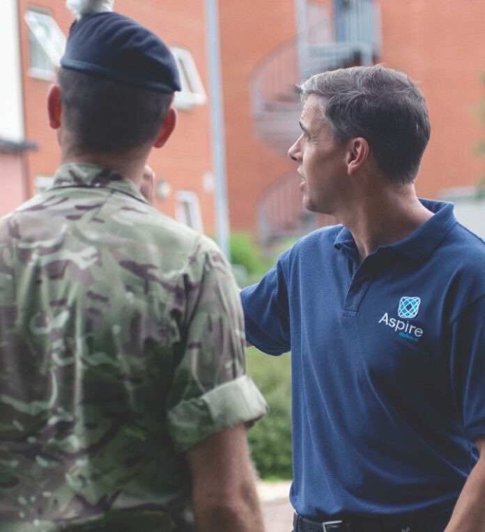 A man in a polo shirt engages in conversation with a veteran in military uniform, discussing life on Civvy Street.