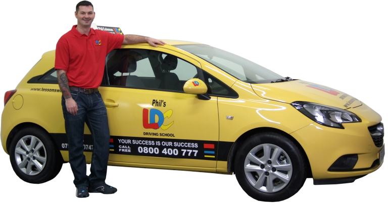 A veteran in a red shirt stands proudly next to a yellow car labeled "Phil's LDC Driving School," embracing his resettlement into civvy street with every lesson taught.