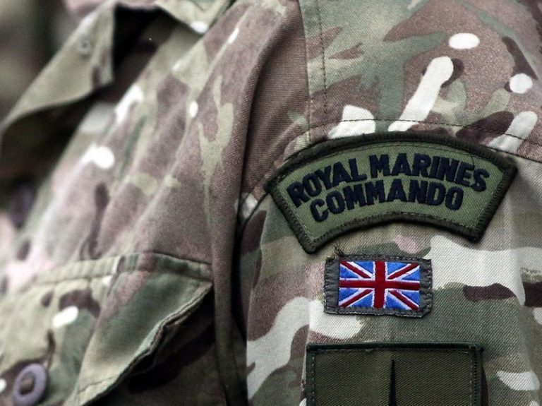 Close-up of a military uniform featuring a "Royal Marines Commando" patch and a Union Jack flag, symbolizing the valor of veterans transitioning to Civvy Street.