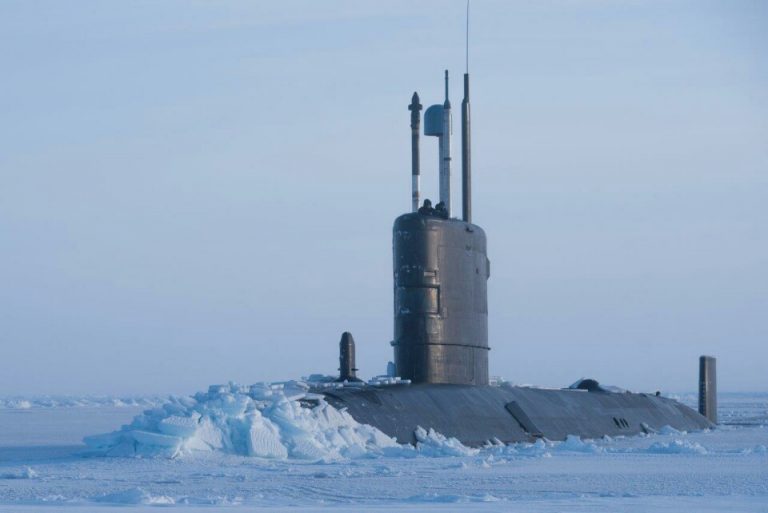 A veteran submarine emerges from a frozen sea, surrounded by ice, as it transitions from the deep to civvy street.