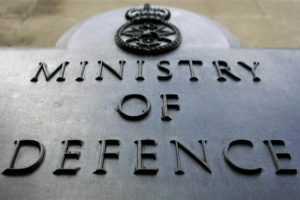 Sign with "Ministry of Defence" and a crown emblem displayed on a metal surface, evoking the journey from service to Civvy Street.