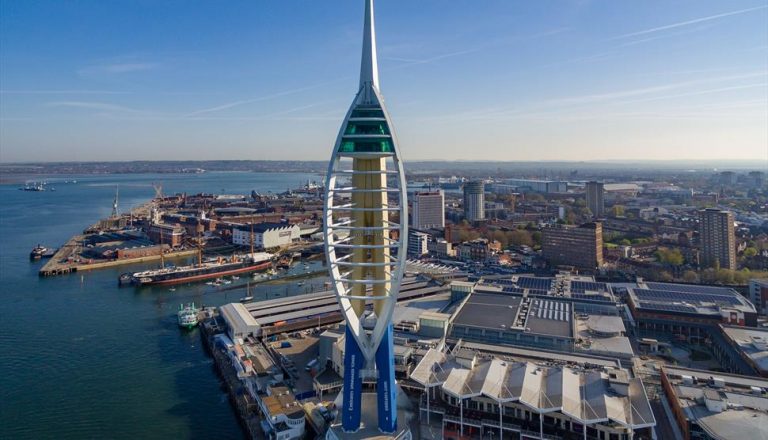 Aerial view of the Spinnaker Tower in Portsmouth, England, highlighting the cityscape and harbor, a vibrant area where veterans find resettlement into civvy street.