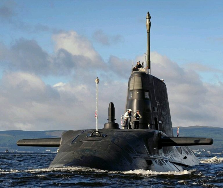 A submarine partially emerges from the water, with a few veteran crew members on deck, against a backdrop of distant hills and blue sky, contemplating life beyond the waves on Civvy Street.