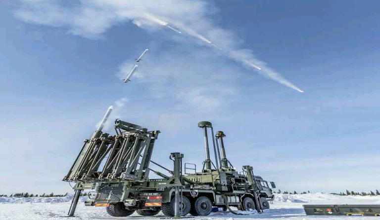 A military vehicle, reminiscent of the Royal Navy's formidable presence, launches multiple missiles in a snowy landscape under a clear blue sky.