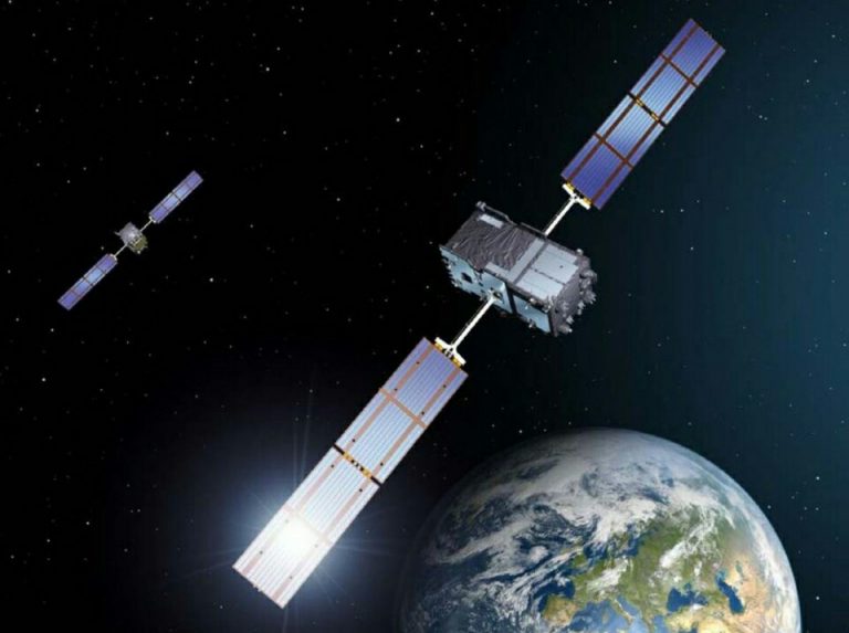 Two satellites, part of the Pathfinder mission, orbit Earth with solar panels extended against a backdrop of space.
