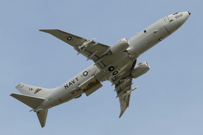 A U.S. Navy aircraft, marked with "NAVY" and insignia, is flying in the sky like a true Pathfinder, with landing gear deployed.