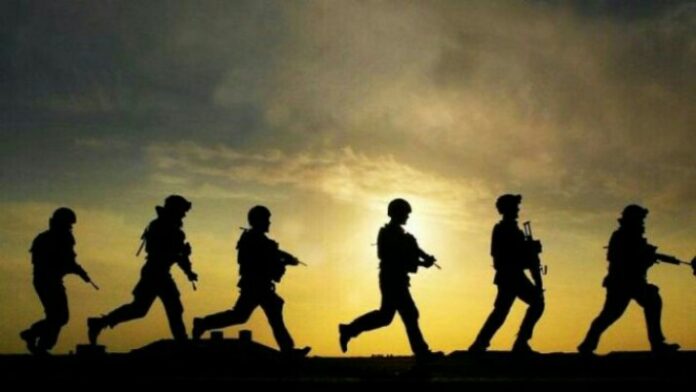 Silhouetted soldiers, reminiscent of seasoned veterans, move in formation with rifles against a sunset backdrop.