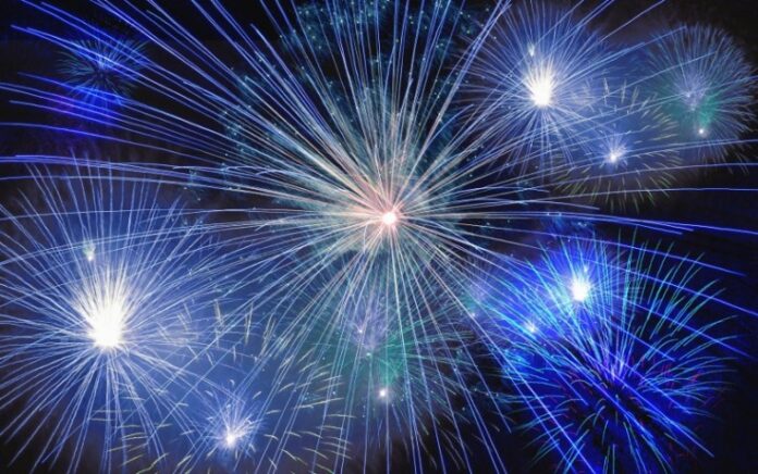 Colorful blue and white fireworks, reminiscent of stars sparkling in the night sky, burst with brilliance.