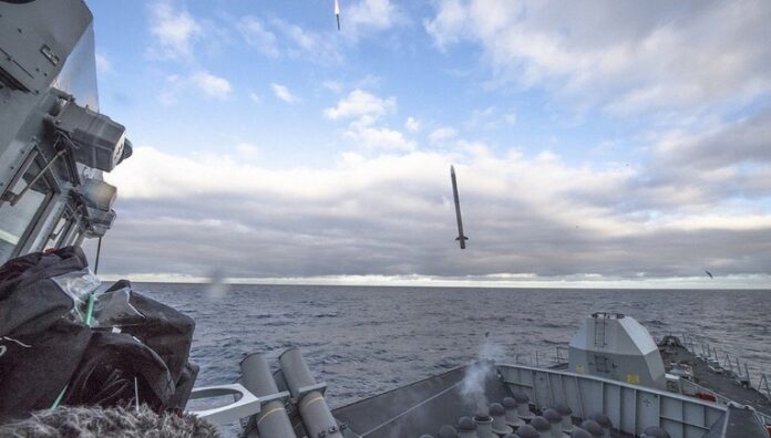 A next-gen missile is being launched from a naval ship at sea under a cloudy sky, showcasing the pinnacle of air defense innovation.