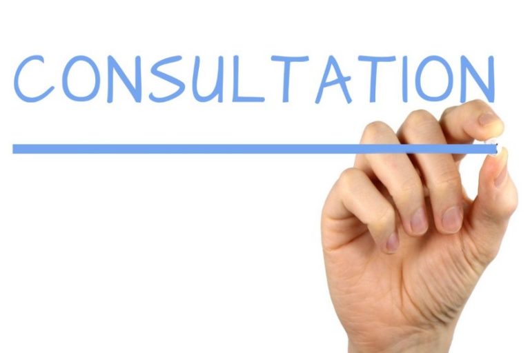 A hand holding a blue marker writes the word "CONSULTATION" with a line underneath on a white background, marking the launch of an important mental health fund initiative.
