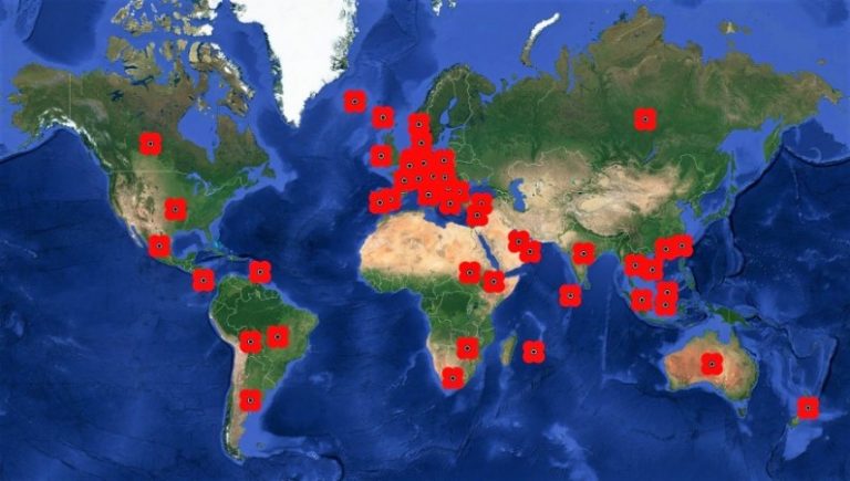 World map with red markers scattered across the globe, highlighting various locations on every continent except Antarctica, as if inviting one to take flight on a journey of discovery.