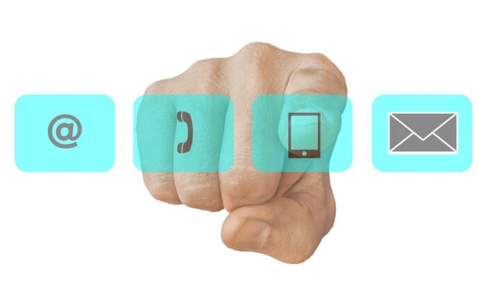 A hand pointing forward highlights the Veterans’ Gateway, with icons for email, phone, mobile, and mail neatly arranged in blue squares.