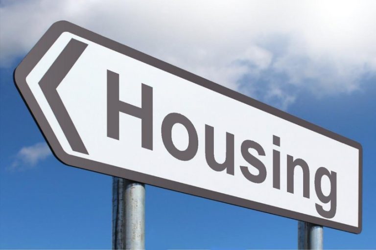 A road sign with an arrow pointing left and the words "Housing Offer" against a blue sky with clouds, guiding service leavers towards opportunities.