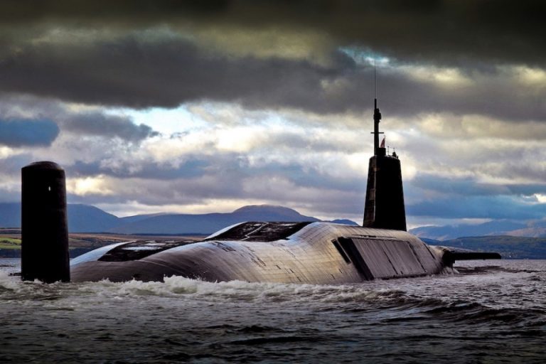 A deal of swift stealth, the submarine glides through waves under a cloudy sky, its nuclear propulsion ensuring a relentless journey with distant mountains standing as silent witnesses in the background.