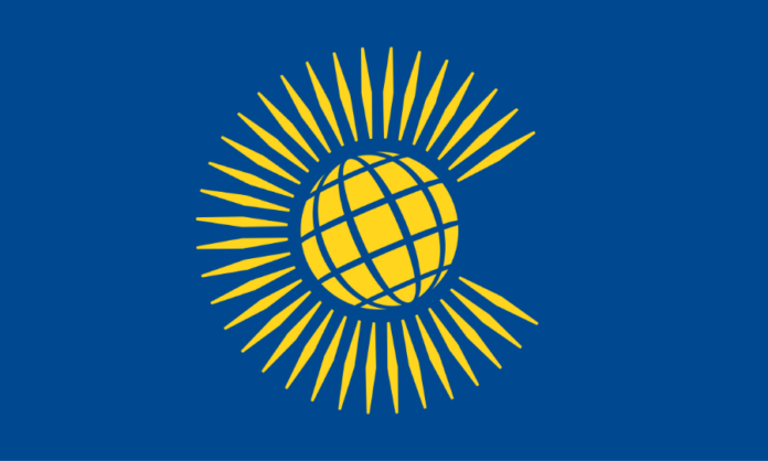 The flag of the Commonwealth showcases a yellow globe with radiating lines on a blue background, symbolizing unity amidst diversity. This emblem stands resilient despite discussions on unfair visa costs or legion calls for change within the organization.