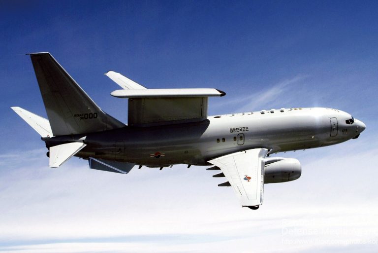 An E-737 Wedgetail airborne early warning and control aircraft elegantly manages the battlespace as it soars through a clear blue sky.