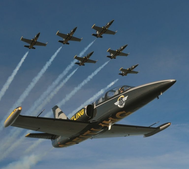 A formation of the world’s finest seven jets performs an aerial maneuver against a clear blue sky, captivating onlookers at the Blackpool Air Show.