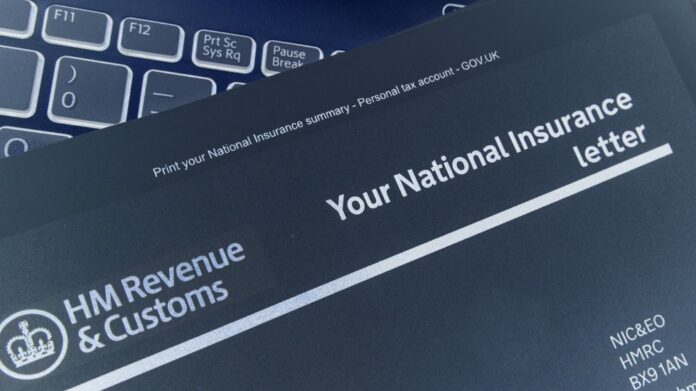 A National Insurance letter from HM Revenue & Customs, often relevant for deployed personnel and their partners, is placed on a laptop keyboard.