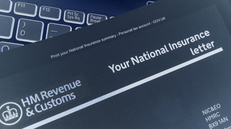 A National Insurance letter from HM Revenue & Customs, often relevant for deployed personnel and their partners, is placed on a laptop keyboard.