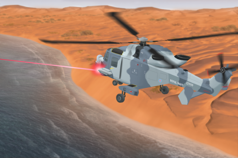 A helicopter flies over the desert landscape, deploying a cutting-edge red laser beam towards the water below.