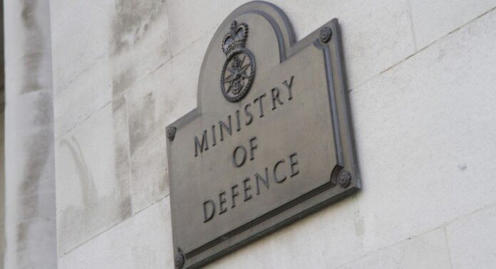 A gold-etched metal plaque on a stone wall reads 