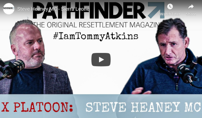 Two men engage in conversation, speaking into microphones in a video titled 