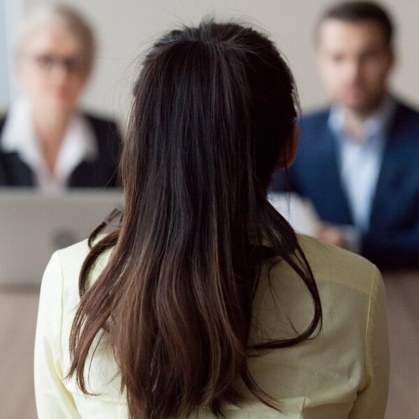 Businesswoman and businessman HR manager interviewing woman