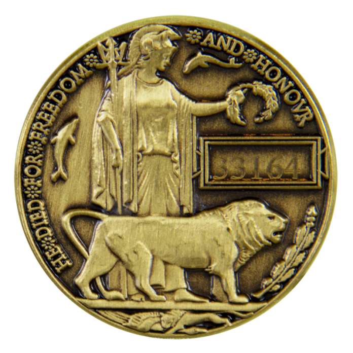 A bronze memorial medallion featuring Britannia holding a wreath, a lion at her feet, the inscription 