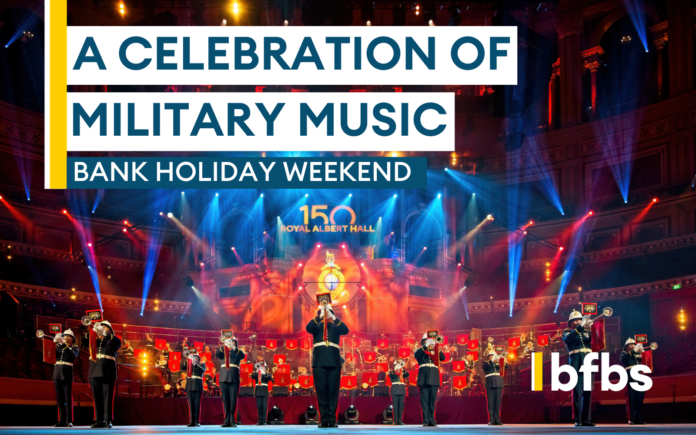 A military Pathfinder band performs on stage at the Royal Albert Hall, with bright stage lights and event banners reading 