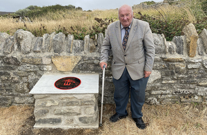 Naval historian and former Chairman of the Weymouth and Portland Residents Association, Alvin Hopper, alongside the newly unveiled memorial plaque. Crown Copyright / MOD 2022.