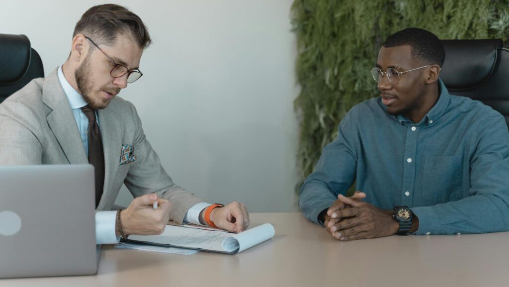 Man in Professional Clothing Reading a Resume