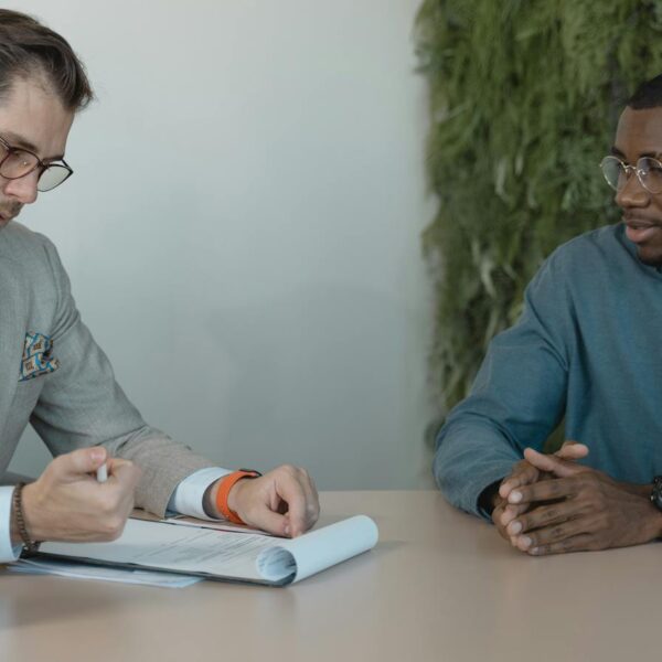 Man in Professional Clothing Reading a Resume