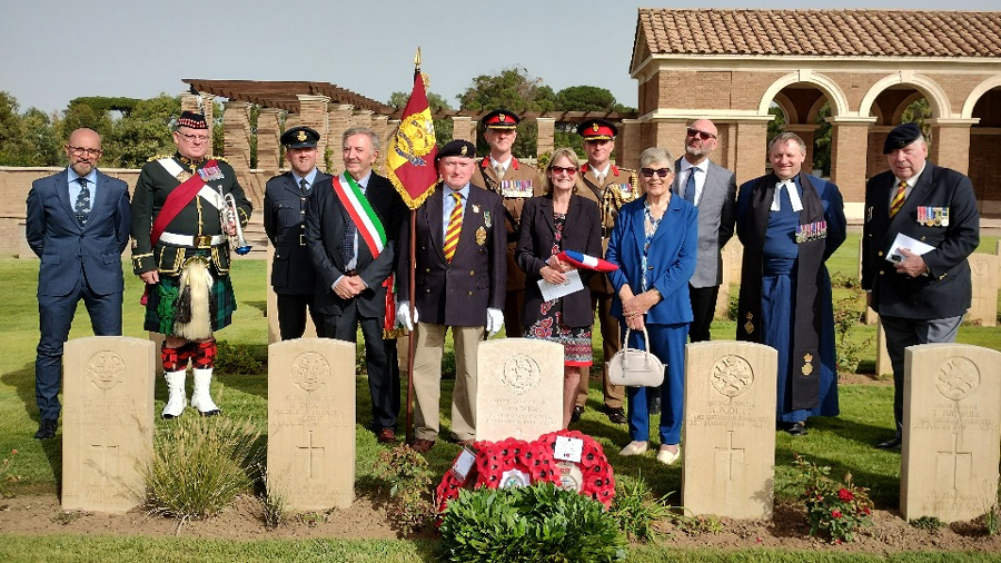 Tracy, the granddaughter of Cpl Owens, stands behind his headstone with members of the military party and other dignitaries (Crown Copyright)