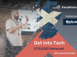 TechVets. A man speaks at a tech event in front of a screen showing the Scottish flag and event details for "Get into Tech," scheduled for 7 October 2025 in Motherwell, highlighting opportunities in tech careers.