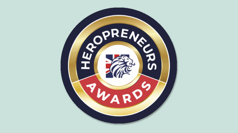 Heropreneurs Awards logo featuring a gold, black, red, and white circular badge with a lion head and Union Jack flag at the center—an emblem representing the 2025 finalists of the Heropreneurs Awards.