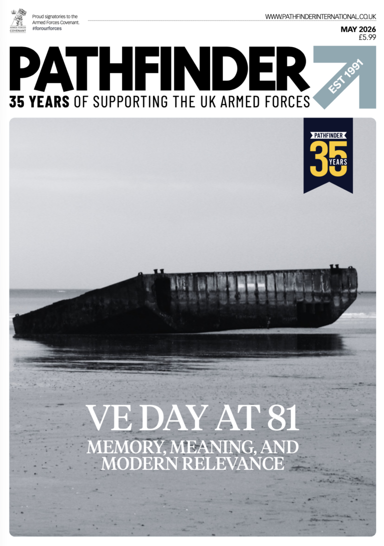 A large, rusted military vessel sits partially submerged in calm water under a cloudy sky. The magazine cover reads "VE Day at 81: Memory, Meaning, and Modern Relevance.